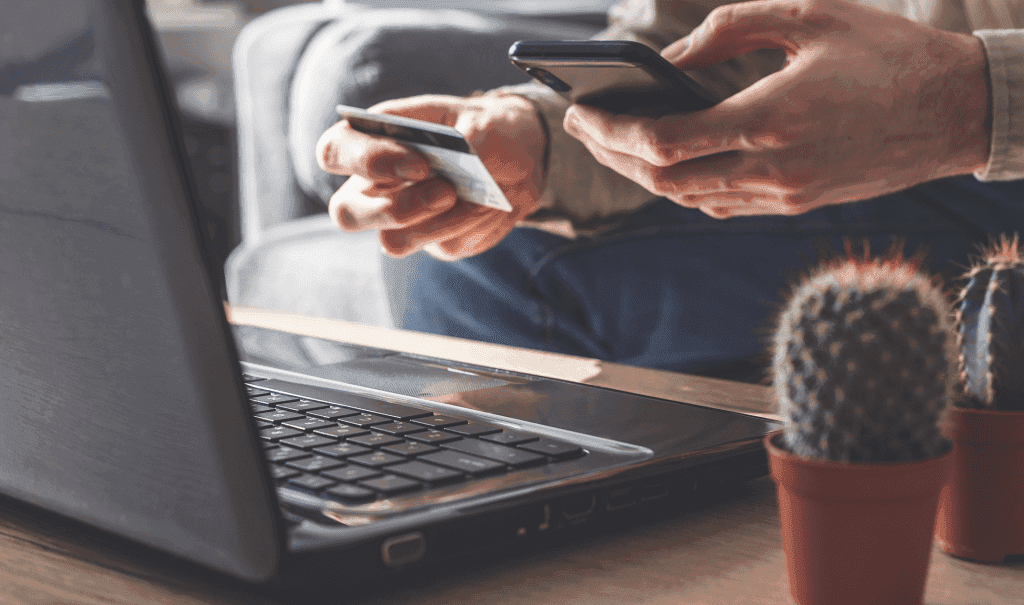 a person holding a credit card and a phone